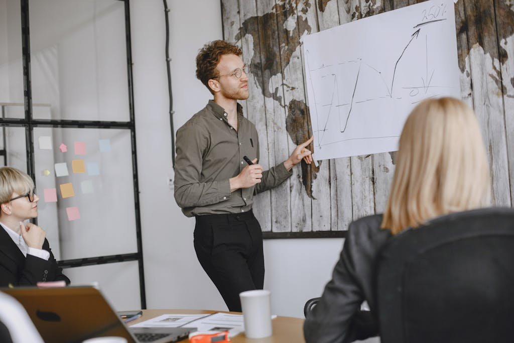 A group of professionals engaged in a business meeting with a presentation in a modern office.